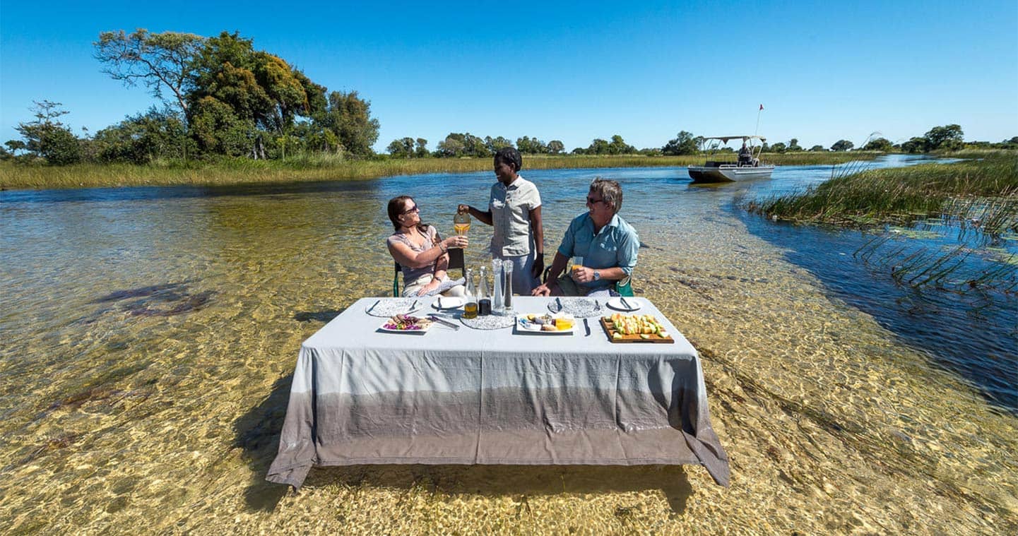 Tourist having lunch at the river on the national park